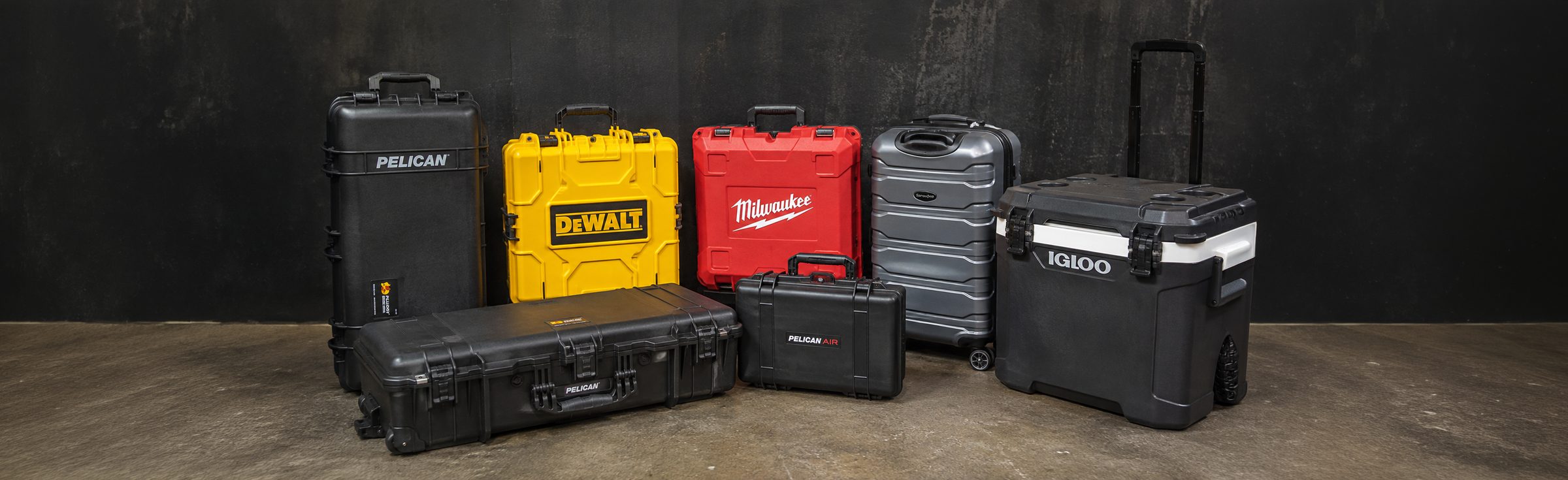 A lineup of hard cases from Pelican, DeWalt, Milwaukee, and Samsonite, plus a rolling cooler, against a dark backdrop